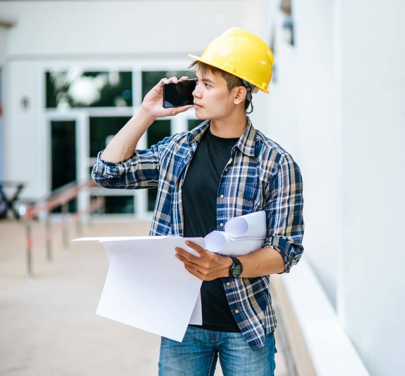 architects-hold-floor-plans-and-talk-on-the-phone-1-1.jpg